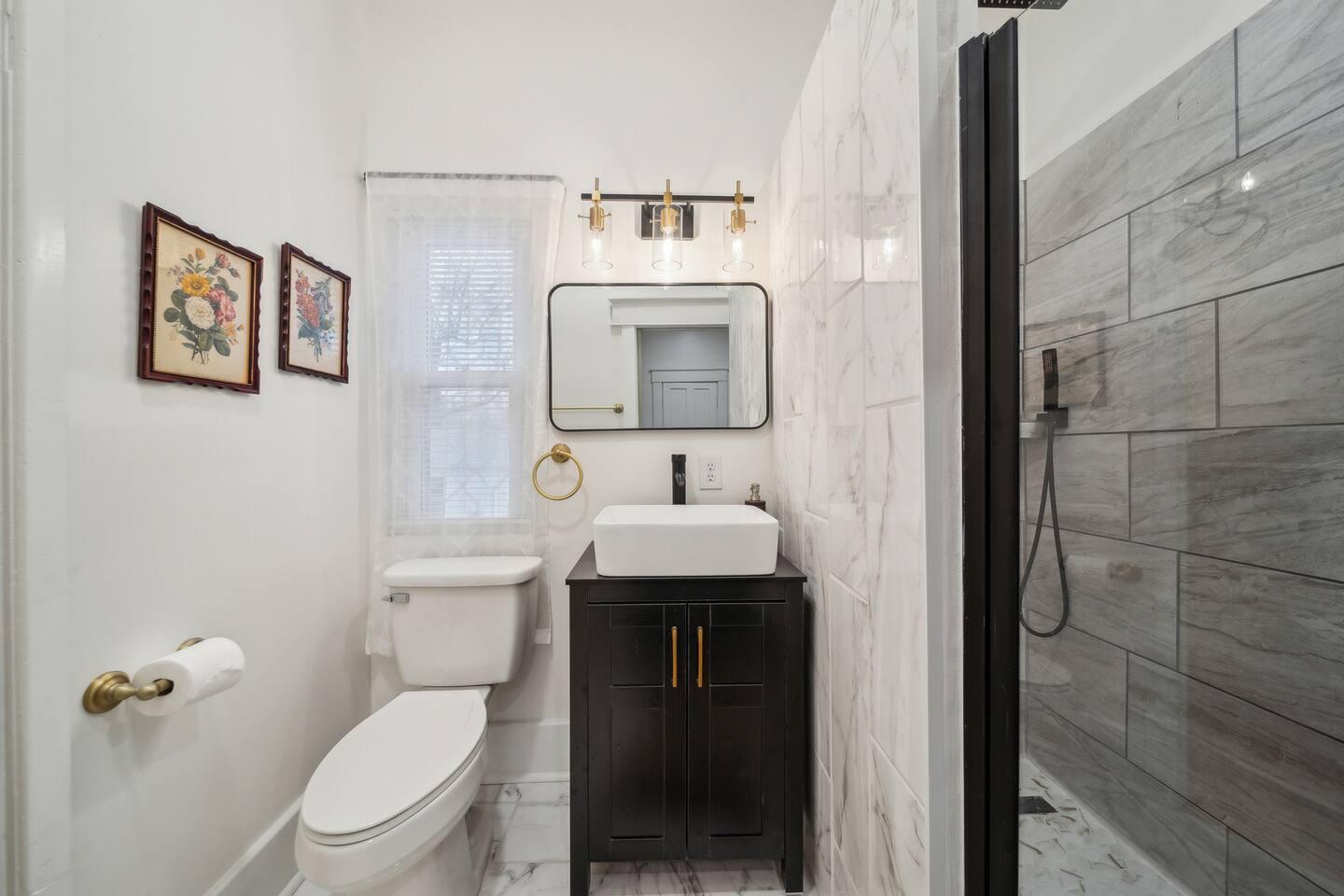 Master Bathroom - Walk-in rainfall shower, modern vanity, and luxury toiletries for a spa-like experience.