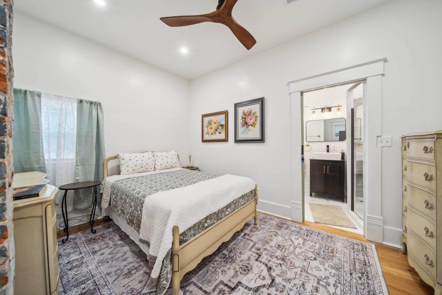 Master Bedroom - Queen bed with plush bedding, ensuite bath, and soft natural lighting.