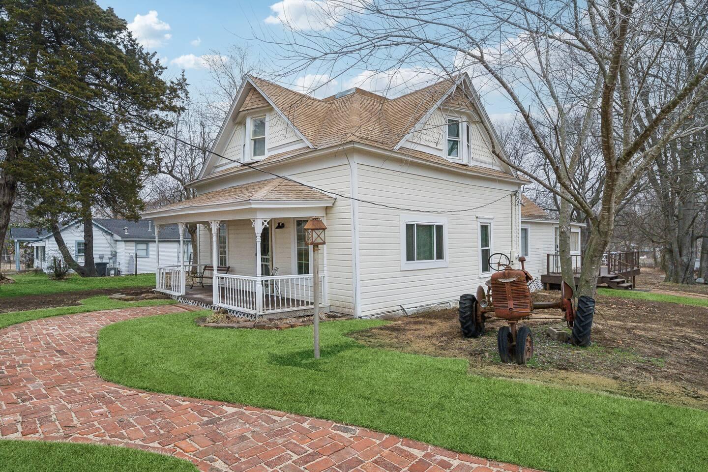 Front porch - Relax on the charming wraparound porch with vintage seating and peaceful country views.