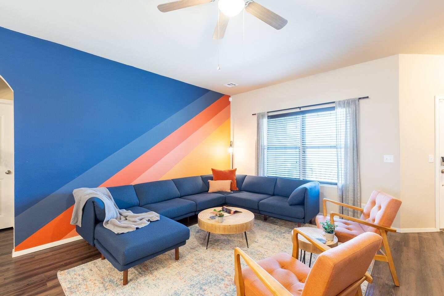 Living room - Large wrap around sectional with a 65 inch TV.
