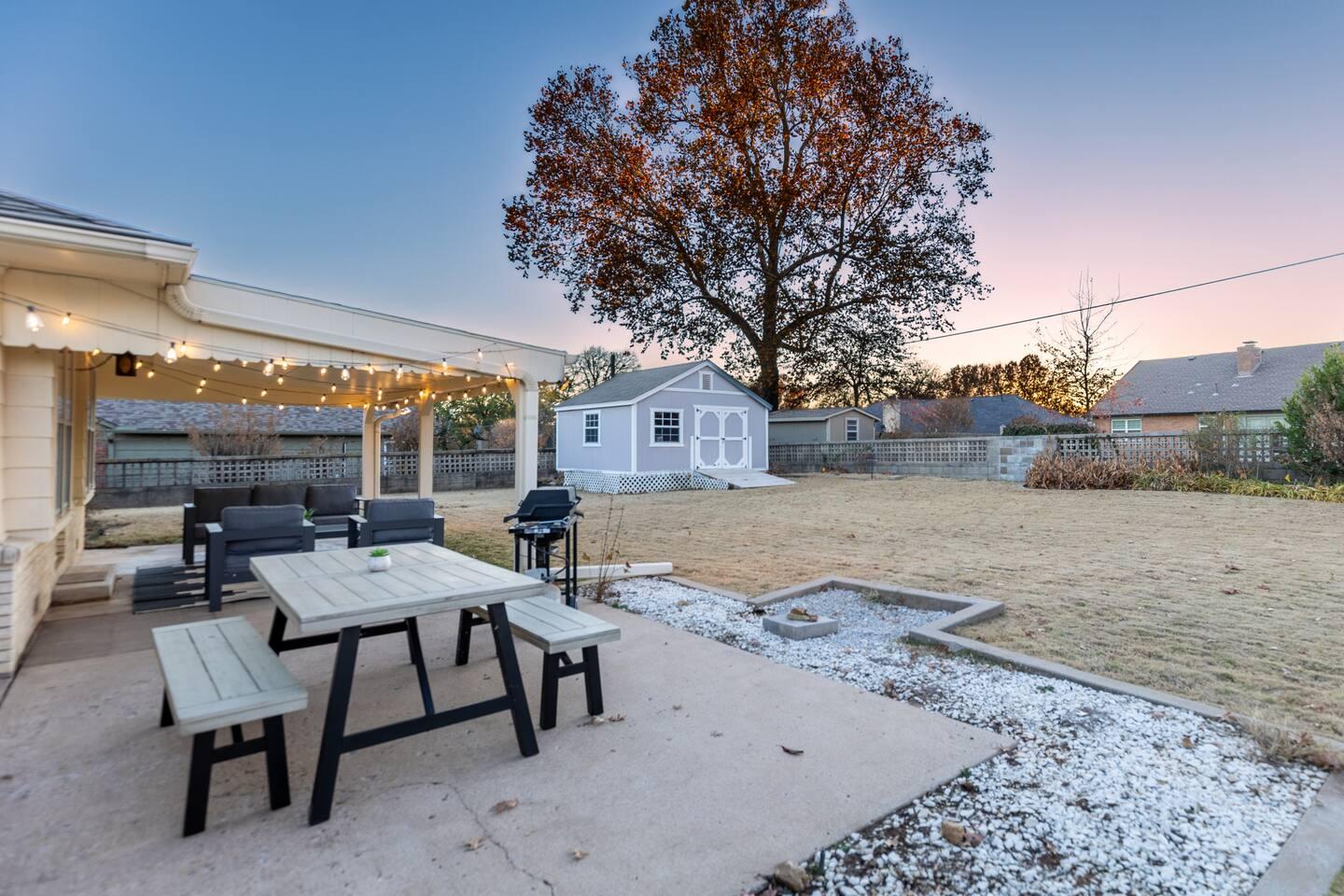 Back patio - Large patio space with outdoor sofas and chairs under a covered patio. Outdoor dining table & propane grill are great for grilling your favorite foods and enjoying the large backyard.