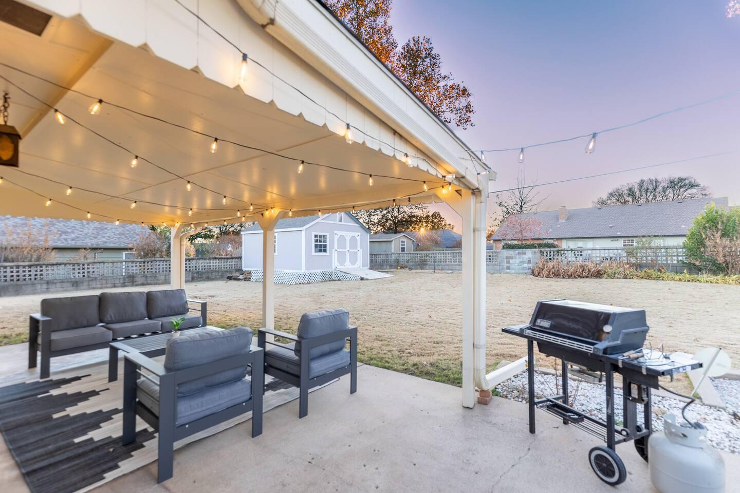 Back patio - Large patio space with outdoor sofas and chairs under a covered patio. Outdoor dining table & propane grill are great for grilling your favorite foods and enjoying the large backyard.