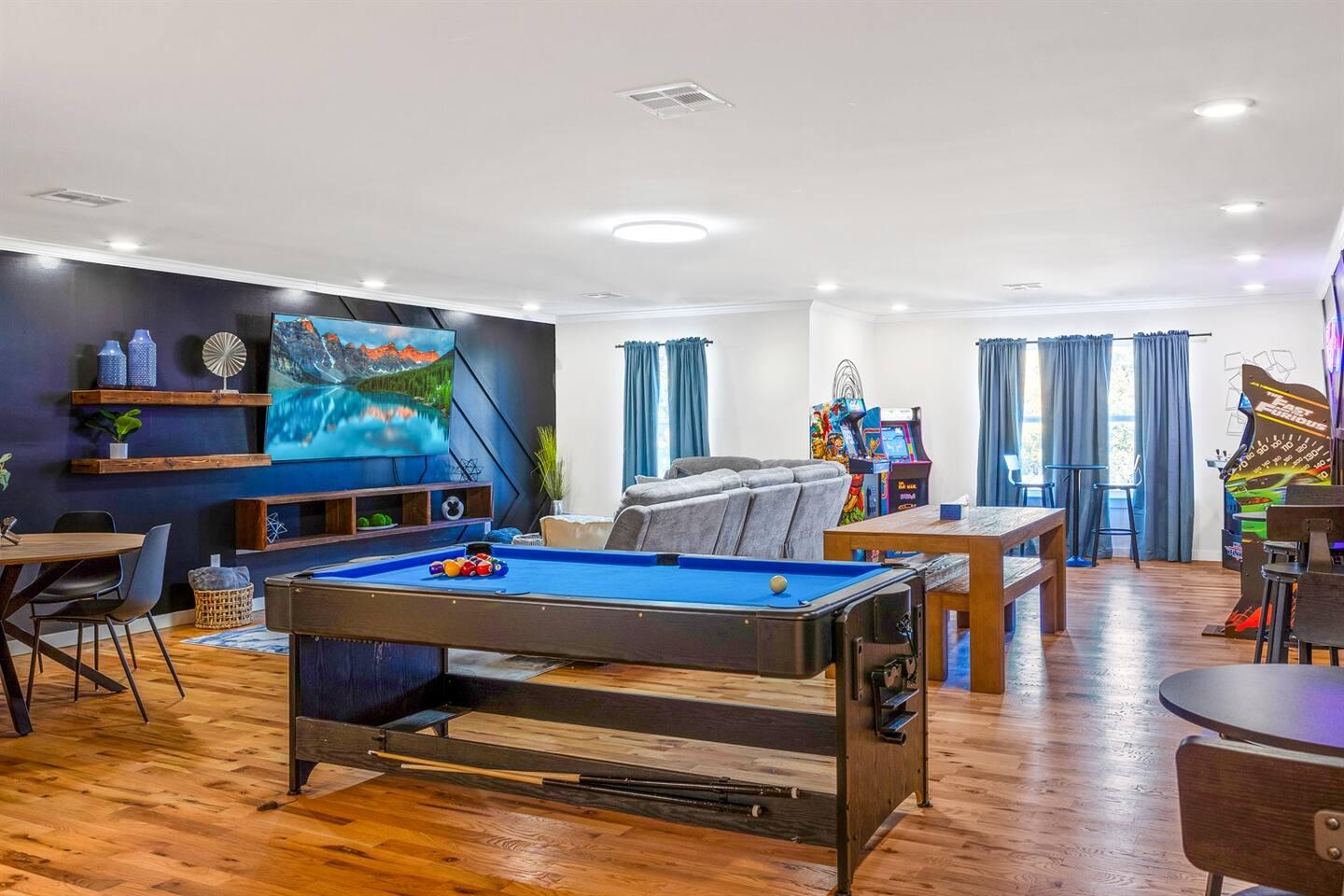 Game room - Equipped with 6 arcade machines, pool/air hockey table, game table with over 15 board games, dining/meeting table & benches and an 85-inch TV.